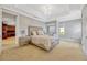 Elegant main bedroom featuring a tray ceiling, carpet and a large window at 9018 Southern Breeze Dr, Orlando, FL 32836