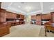 Large home office with custom wood cabinetry, built-in desks, and ample storage at 9018 Southern Breeze Dr, Orlando, FL 32836
