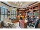 Home office with custom built-in shelves and cabinets, desk space, and natural light at 9018 Southern Breeze Dr, Orlando, FL 32836