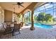 Covered outdoor pool area featuring an outdoor kitchen and exposed brick columns at 9018 Southern Breeze Dr, Orlando, FL 32836