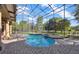 Screened-in pool and spa featuring brick surround, patio, and view of the backyard at 9018 Southern Breeze Dr, Orlando, FL 32836