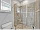 Updated glass shower with tiled walls, sleek fixtures, and bright natural light at 9018 Southern Breeze Dr, Orlando, FL 32836