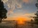 Beautiful sunset over the water with docks, city buildings and ferris wheel in distance at 9018 Southern Breeze Dr, Orlando, FL 32836