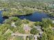 High aerial view of a lakeside neighborhood with mature trees and a swimming pool at 29 Windsor Isle Dr, Longwood, FL 32779