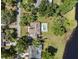 Aerial view of a ranch style home with an in-ground pool and lake access at 29 Windsor Isle Dr, Longwood, FL 32779