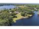 Wide angle aerial view of a neighborhood with homes, trees and a lake at 29 Windsor Isle Dr, Longwood, FL 32779