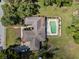 Aerial view of property featuring a large roof, pool and surrounding landscape at 29 Windsor Isle Dr, Longwood, FL 32779