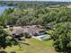 Aerial view of a home with screened porch, swimming pool and lake view at 29 Windsor Isle Dr, Longwood, FL 32779