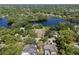 High aerial view of a lakeside neighborhood with mature trees and large lake at 29 Windsor Isle Dr, Longwood, FL 32779