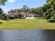 Back view of a single Gathering house with a patio and lake in background at 29 Windsor Isle Dr, Longwood, FL 32779