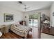 Bright bedroom with hardwood floors, ceiling fan, and a sliding glass door to the pool at 29 Windsor Isle Dr, Longwood, FL 32779