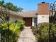 The front entrance features a double door, brick chimney, and fresh landscaping at 29 Windsor Isle Dr, Longwood, FL 32779