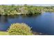 Scenic view of a tranquil lake surrounded by lush trees, offering a peaceful and picturesque setting at 29 Windsor Isle Dr, Longwood, FL 32779