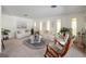 Bright living room featuring plush white sofas, a glass-topped table, and lots of natural light through multiple windows at 29 Windsor Isle Dr, Longwood, FL 32779
