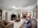 Spacious living room featuring a brick fireplace, tile floors, and comfortable seating at 29 Windsor Isle Dr, Longwood, FL 32779