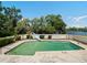 In-ground pool with slide overlooking mature trees and a beautiful body of water at 29 Windsor Isle Dr, Longwood, FL 32779
