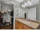 A bathroom with light wood cabinets, granite countertops, a white sink, and a walk-in closet in the background at 101 S Eola Dr # 1018, Orlando, FL 32801