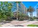 Modern condo building featuring multiple stories with balconies and street-level retail space at 101 S Eola Dr # 1018, Orlando, FL 32801
