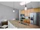 Modern kitchen featuring granite countertops, stainless steel appliances and a breakfast bar with seating at 101 S Eola Dr # 1018, Orlando, FL 32801