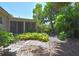 A serene backyard with lush landscaping, a screened lanai, and a stone walkway for outdoor enjoyment at 1125 N Mc Donald St, Mount Dora, FL 32757