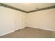 Bedroom featuring patterned linoleum, wallpaper trim, and two white doors at 1125 N Mc Donald St, Mount Dora, FL 32757