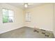 Modest bedroom features two windows that provide natural light and an overhead ceiling fan at 1125 N Mc Donald St, Mount Dora, FL 32757