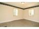 Empty bedroom featuring two windows, patterned linoleum, and decorative wallpaper trim at 1125 N Mc Donald St, Mount Dora, FL 32757