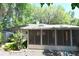 Home exterior features a screened in porch, mature trees, and well-maintained grounds at 1125 N Mc Donald St, Mount Dora, FL 32757