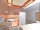 Kitchen featuring neutral cabinets, appliances, and view into a spacious area at 1125 N Mc Donald St, Mount Dora, FL 32757