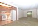 Cozy kitchen with vintage cabinets and appliances, seamlessly connecting to the living area at 1125 N Mc Donald St, Mount Dora, FL 32757