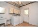 Functional laundry room featuring a washer, dryer, sink, and upper cabinets for ample storage space at 1125 N Mc Donald St, Mount Dora, FL 32757