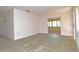 Empty living room features an open floor plan with an exterior door and large windows at 1125 N Mc Donald St, Mount Dora, FL 32757