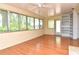 Bright sunroom featuring wood floors, a ceiling fan, and lots of windows at 1125 N Mc Donald St, Mount Dora, FL 32757