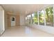 Inviting sunroom featuring many windows and doors offering views of the surrounding garden at 1125 N Mc Donald St, Mount Dora, FL 32757