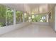 Bright sunroom with many windows providing abundant natural light and views of the lush outdoor greenery at 1125 N Mc Donald St, Mount Dora, FL 32757