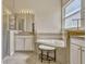 Bright bathroom featuring a soaking tub with tile surround, vanity, and separate shower at 115 Crescent Moon Dr, Groveland, FL 34736