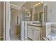 Bathroom featuring a glass enclosed shower, vanity with sink, mirror, and tile flooring at 115 Crescent Moon Dr, Groveland, FL 34736