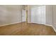 Clean bedroom with wood floors and a double door closet providing storage space and a comfortable retreat at 115 Crescent Moon Dr, Groveland, FL 34736