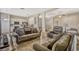 Spacious living room featuring tile flooring, comfortable seating, and an open floor plan to the kitchen at 115 Crescent Moon Dr, Groveland, FL 34736
