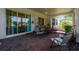 Screened patio featuring ceiling fan, brick floor and multiple chairs at 115 Crescent Moon Dr, Groveland, FL 34736
