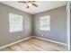 Bedroom with neutral paint, updated flooring, two windows allowing plenty of natural light at 1234 Parker Ave, Deltona, FL 32725