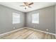 Bedroom featuring neutral paint, updated flooring, and two windows allowing in plenty of natural light at 1234 Parker Ave, Deltona, FL 32725