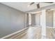 Bright bedroom featuring wood floors, light gray walls, and natural light from window at 1234 Parker Ave, Deltona, FL 32725