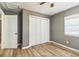 Cozy bedroom featuring laminate flooring, a closet, and a window with natural light at 1234 Parker Ave, Deltona, FL 32725