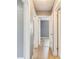 Hallway featuring light hardwood flooring and multiple doorways leading to other rooms at 1234 Parker Ave, Deltona, FL 32725