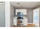 Well-lit kitchen features stainless steel appliances and white cabinetry offering functionality at 1234 Parker Ave, Deltona, FL 32725