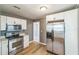 Modern kitchen features stainless appliances, including a microwave, stove, and refrigerator at 1234 Parker Ave, Deltona, FL 32725