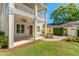 View of covered patio, landscaped yard, and detached garage at 1341 Lyndale Blvd, Winter Park, FL 32789