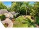 Aerial view of landscaped backyard with lawn, garage, and brick-paved driveway at 1341 Lyndale Blvd, Winter Park, FL 32789