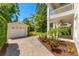 View of backyard with grass, garage, and paved driveway at 1341 Lyndale Blvd, Winter Park, FL 32789